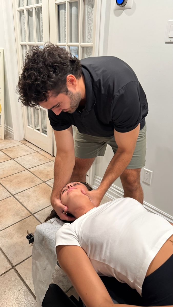 Neck adjustment as part of jaw pain treatment during a home visit