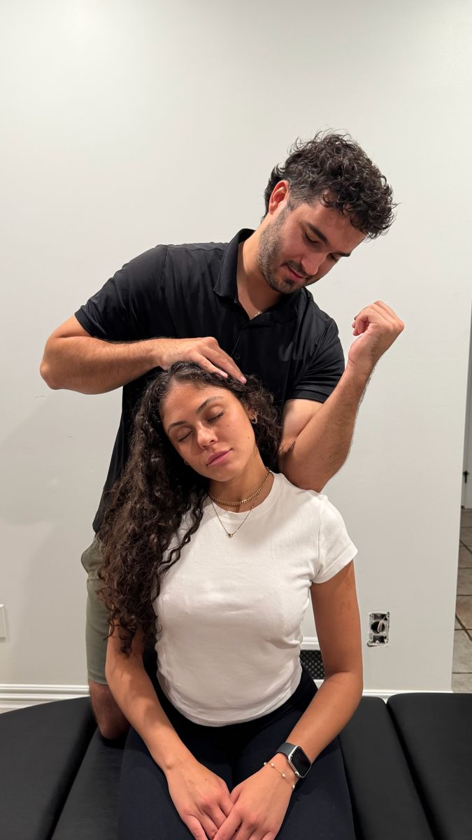 Dr. Alex providing soft tissue therapy to the neck and upper shoulder during a home visit